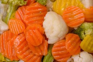 Delicious fresh vegetables broccoli, cauliflower, carrots steamed with salt photo