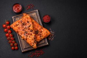 Slices of delicious street pizza with sausage, mushrooms, tomatoes and cheese photo