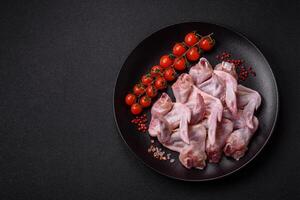 Fresh chicken wings with salt, spices and herbs photo