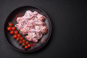 Fresh chicken wings with salt, spices and herbs photo