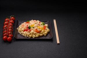 Delicious Asian dish rice noodles or udon with vegetables, spices and herbs photo