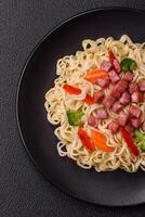 Delicious Asian dish rice noodles or udon with vegetables, spices and herbs photo