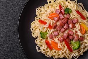 Delicious Asian dish rice noodles or udon with vegetables, spices and herbs photo