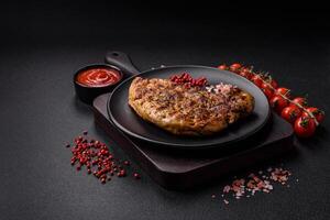 Delicious juicy pork steak with salt, spices and herbs photo