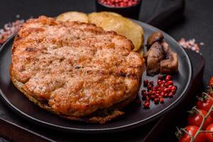 Delicious juicy turkey or chicken steak with salt, spices and herbs photo