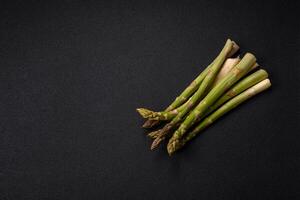 Sprigs of raw green asparagus as an ingredient for preparing a healthy breakfast photo