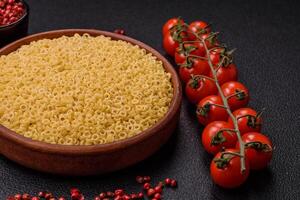 Raw anellini pasta from durum wheat with salt and spices photo