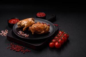 Delicious juicy chicken thighs baked on the grill with salt photo