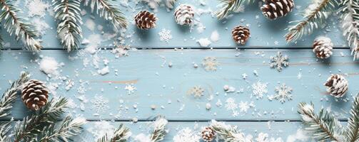 light blue wooden background with snow and pine cones, snowflakes, Christmas decorations photo