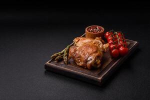 Delicious juicy chicken thighs baked on the grill with salt photo