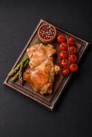 Delicious juicy chicken thighs baked on the grill with salt photo