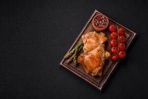Delicious juicy chicken thighs baked on the grill with salt photo