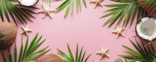 Tropical summer frame border with starfish, coconuts and green palm leaves on pink background photo