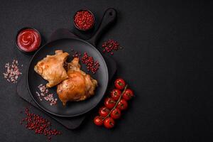 Delicious juicy chicken thighs baked on the grill with salt photo