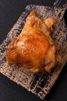 Delicious juicy chicken thighs baked on the grill with salt photo