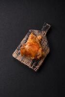Delicious juicy chicken thighs baked on the grill with salt photo