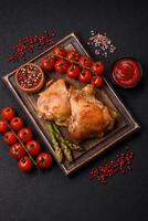 Delicious juicy chicken thighs baked on the grill with salt photo