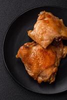 Delicious juicy chicken thighs baked on the grill with salt photo