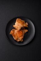 Delicious juicy chicken thighs baked on the grill with salt photo