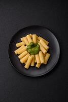 Delicious pasta with spinach sauce, olive oil and parmesan cheese photo