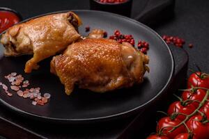 Delicious juicy chicken thighs baked on the grill with salt photo