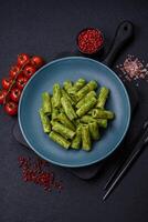 Delicious pasta with spinach sauce, olive oil and parmesan cheese photo