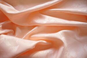 Peach silk or satin crumpled fabric background. Beautiful, delicate and elegant texture. photo