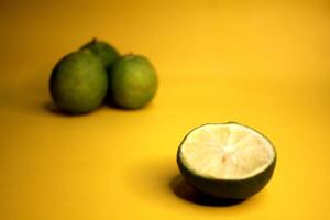 Half the limes are set aside and then separated from the 3 fruits that are still intact. photo