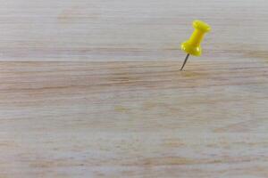 Yellow pin on the wood photo