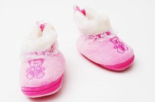 Pair of baby's slippers hanging on a rope. Including copy space photo