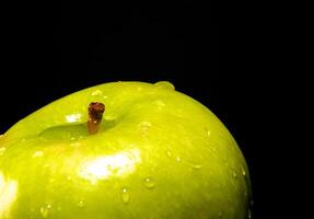 Green apple with water droplets photo