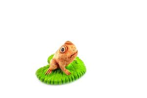 Green frog toy on white photo