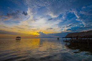 Floating house on the embankment with Sunset photo