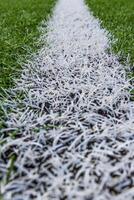 white line on soccer field grass photo