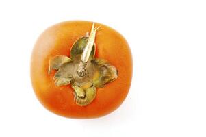 Ripe persimmon on the white background photo