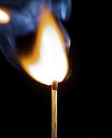 Wooden match burning on a black background photo