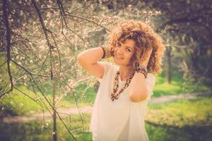 Fashion shot of a beautiful boho style girl on nature background. Boho, hippie. photo