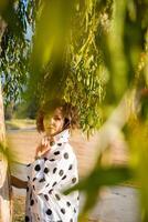 Fashion shot of a beautiful boho style girl on nature background. Boho, hippie. photo