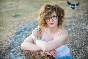 Fashion shot of a beautiful boho style girl on nature background. Boho, hippie. photo