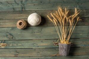 Wheat Ears on the Wooden Table. Sheaf of Wheat over Wood Background. Harvest concept. photo