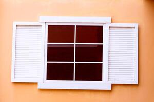 Vintage window on yellow cement photo