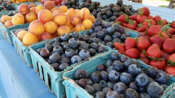 Colorful array of fresh fruits at farmer's market, bursting with flavors of the summer harvest photo