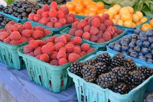 Colorful array of fresh fruits at farmer's market, bursting with flavors of the summer harvest photo