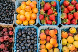 Colorful array of fresh fruits at farmer's market, bursting with flavors of the summer harvest photo