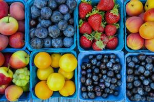 Colorful array of fresh fruits at farmer's market, bursting with flavors of the summer harvest photo