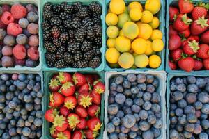 Colorful array of fresh fruits at farmer's market, bursting with flavors of the summer harvest photo