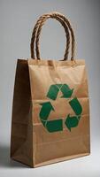 Brown paper bag with recycle symbol displayed on its front side typically composed of three chasing arrows forming a triangle photo