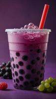 Studio shot of refreshing grape bubble tea with tapioca pearls on the purple background photo