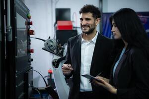 Businessperson of factory industry inspection and testing of robots arm for use in large-scale complex manufacturing industries. photo