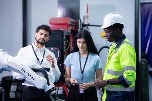 Technicians are introducing industrial hand robots to businessperson of factory industry who will use them in large-scale complex manufacturing operations. photo